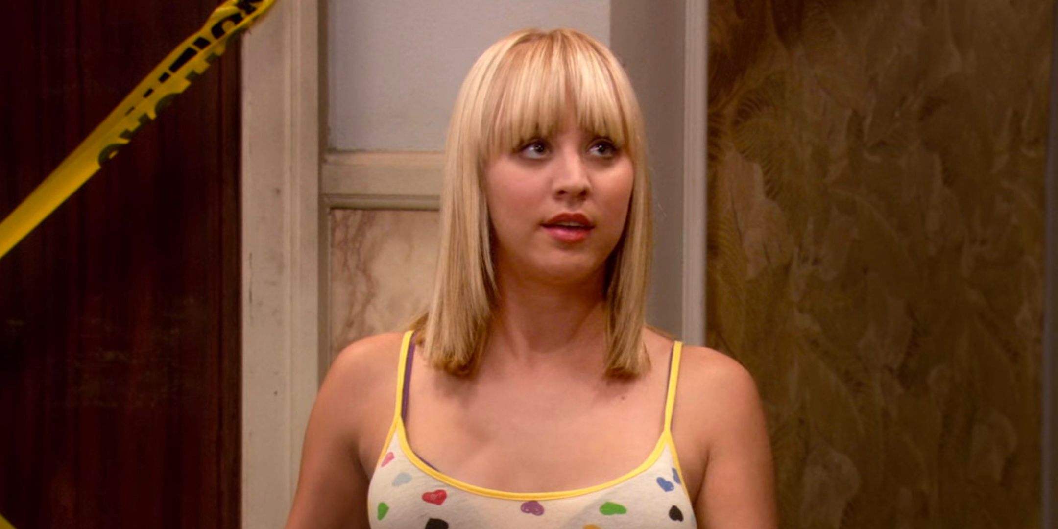 Kaley Cuoco's Penny stands outside the elevator in The Big Bang Theory season 1