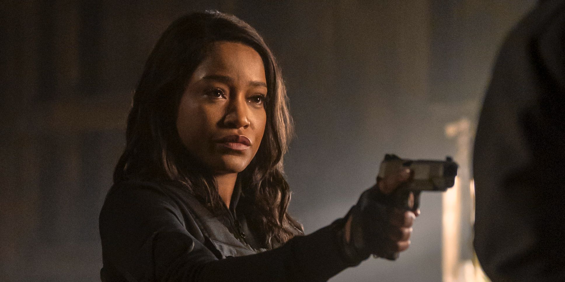 Keke Palmer pointing a gun with an unimpressed expression in The Pickup