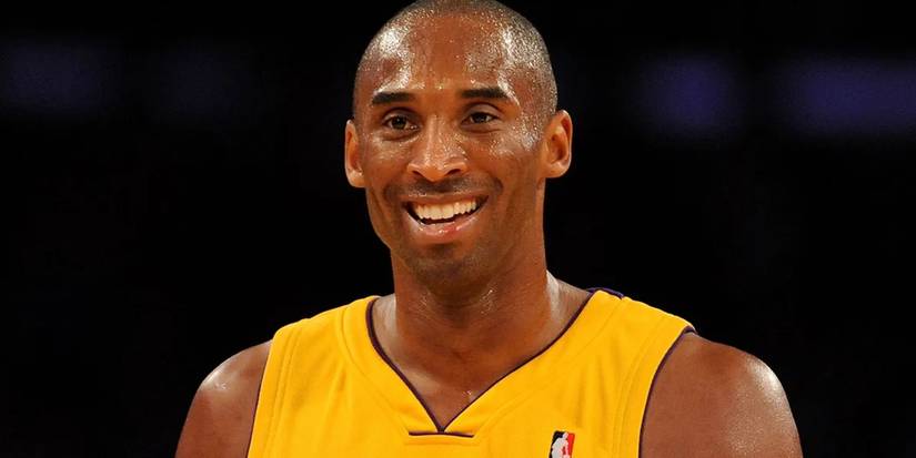 Kobe Bryant is smiling while at a game for the Lakers