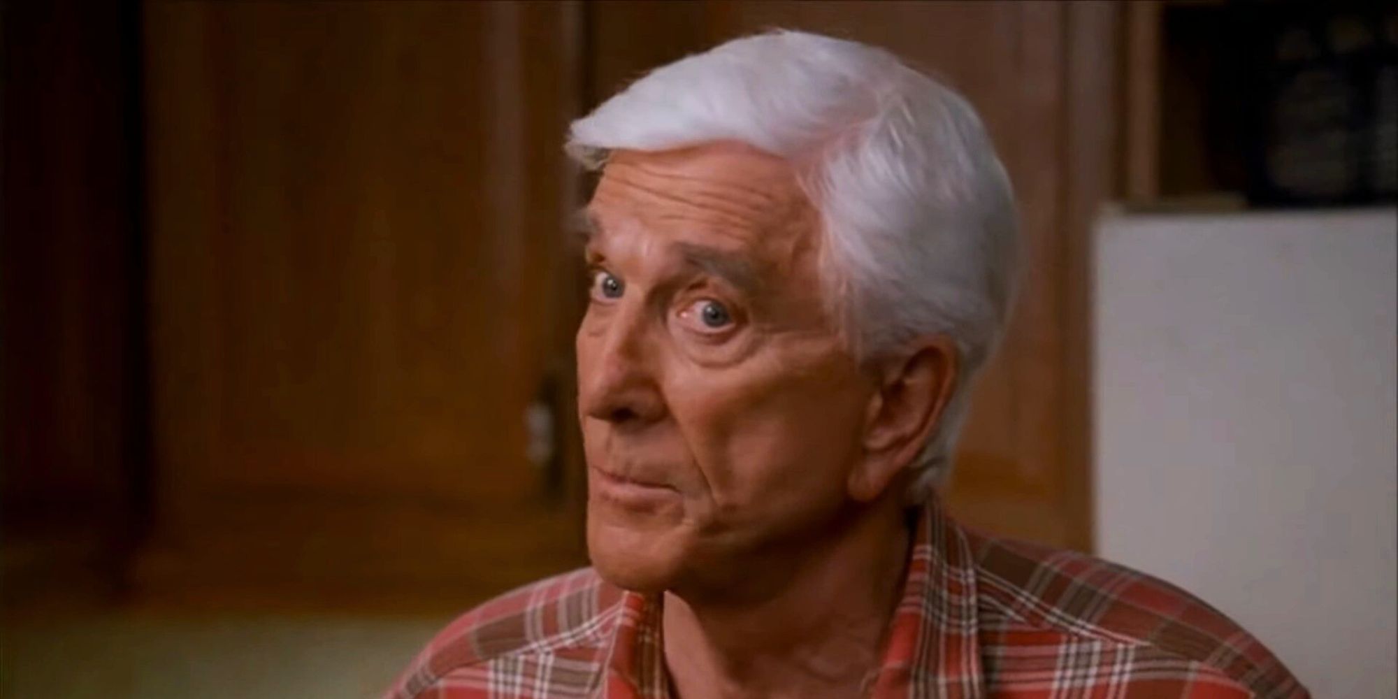 Leslie Nielsen as Albert Riker in the kitchen talking to Rick in Superhero Movie