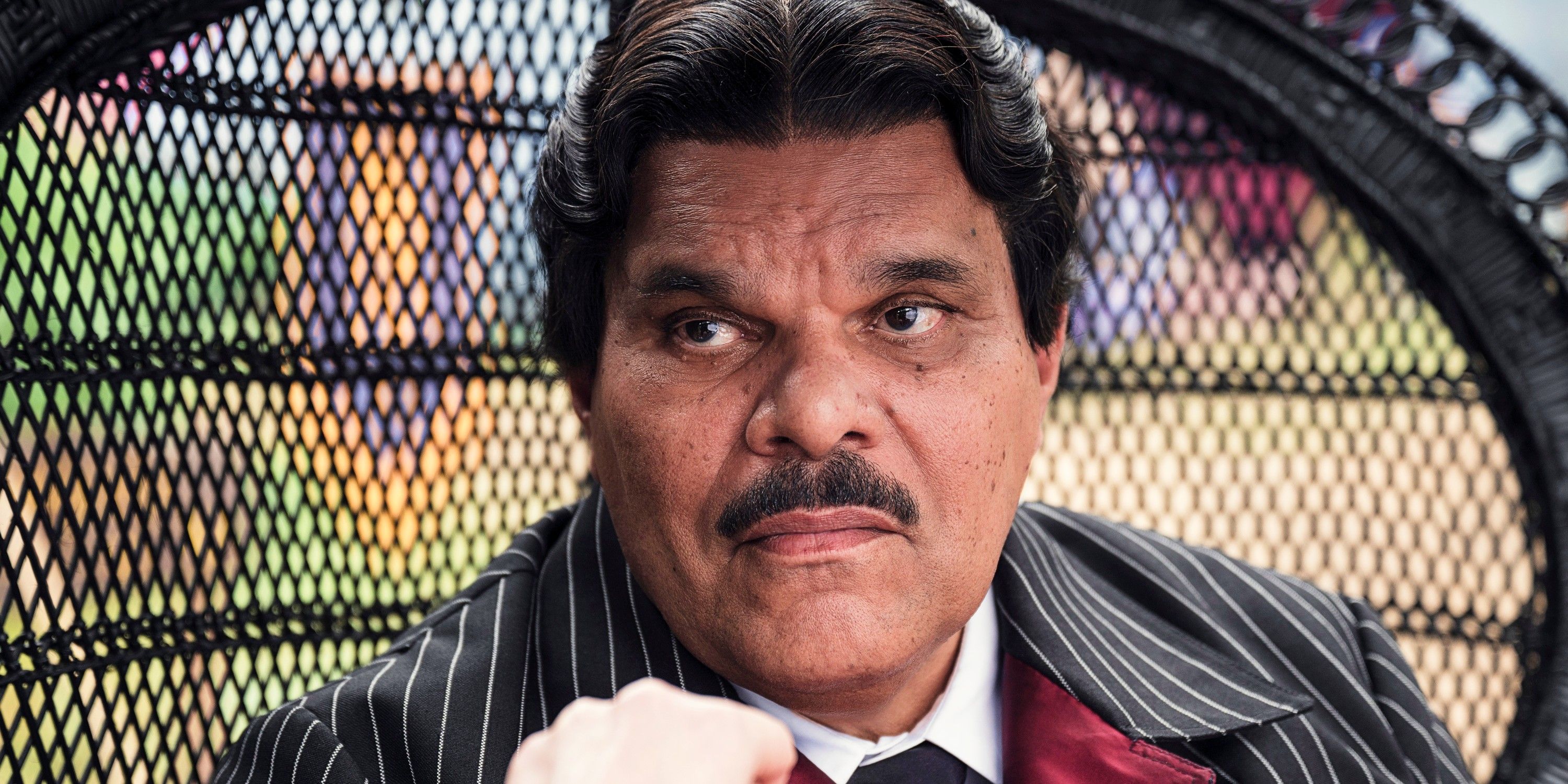 Luis Guzman as Gomez Addams about to kiss Morticia's hand in Wednesday season 2