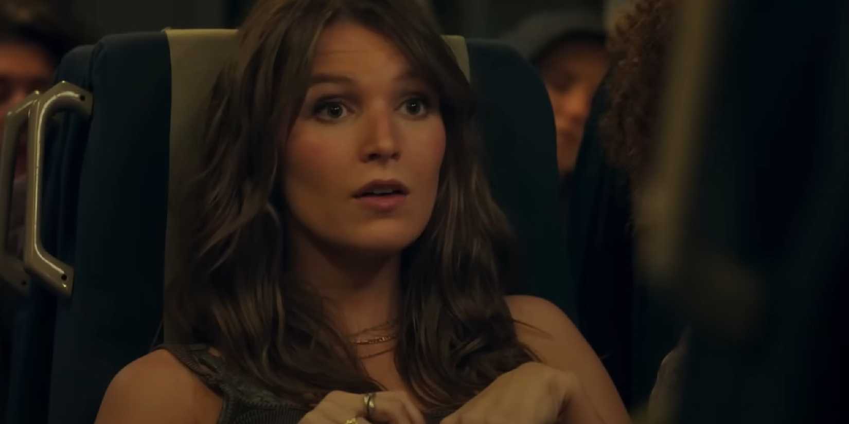 Madison Thompson sits on the train as Amy in The Map that Leads to You