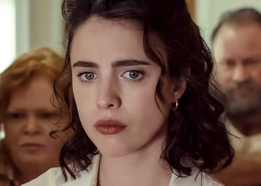 Margaret Qualley walking down a hallway with two others in Honey Don't