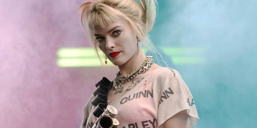 Margot Robbie as Harley Quinn in Birds of Prey with pink and teal smoke behind her.jpg