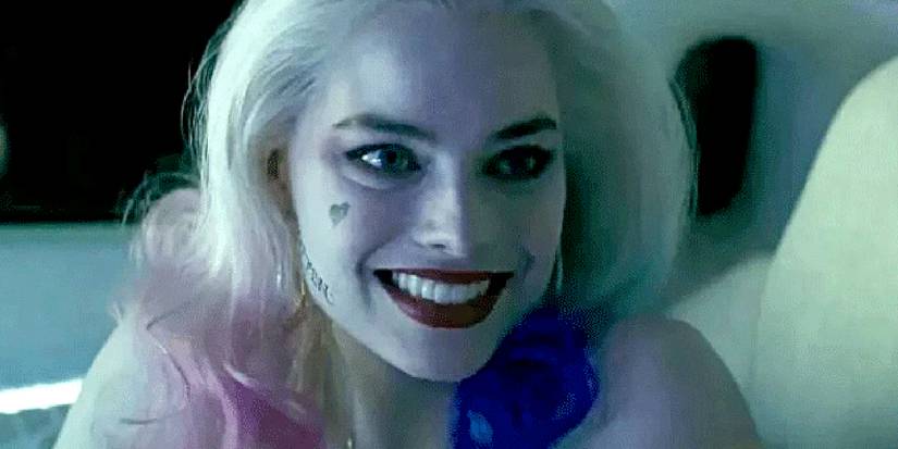 Margot Robbie as Harley Quinn smiles in Joker's car in Suicide Squad