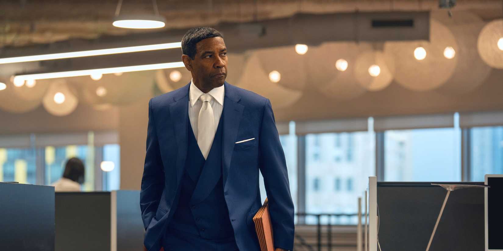 Denzel Washington walking through a building in a nice suit in Highest 2 Lowest