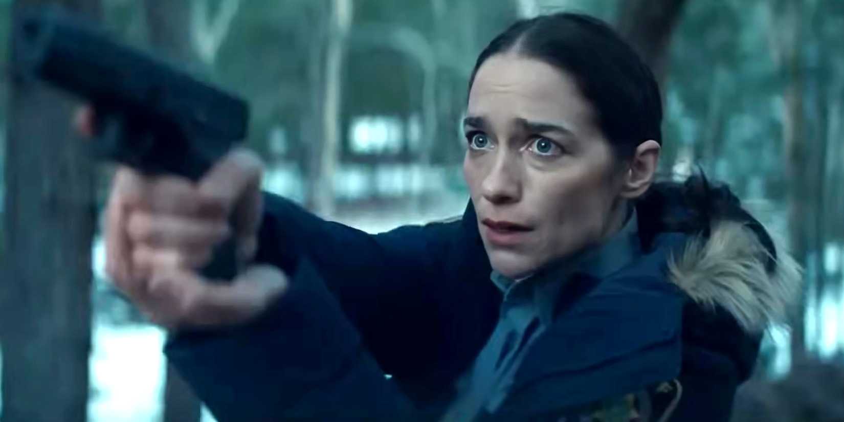 Melanie Scrofano's Dana looking worried while aiming her pistol in Revival