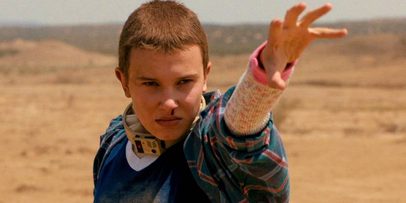 Millie Bobby Brown as Eleven holding out her clawed hand in the desert in Stranger Things season 4