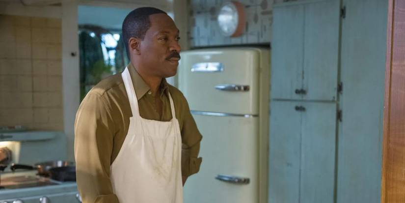 Eddie Murphy stands in a kitchen with his hand on his hip in Mr. Church
