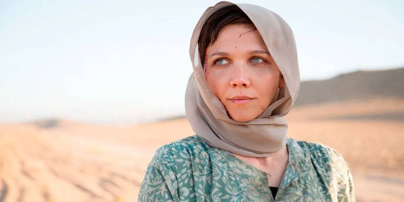 Nessa (Maggie Gyllenhaal) smiling in a desert in The Honourable Woman.