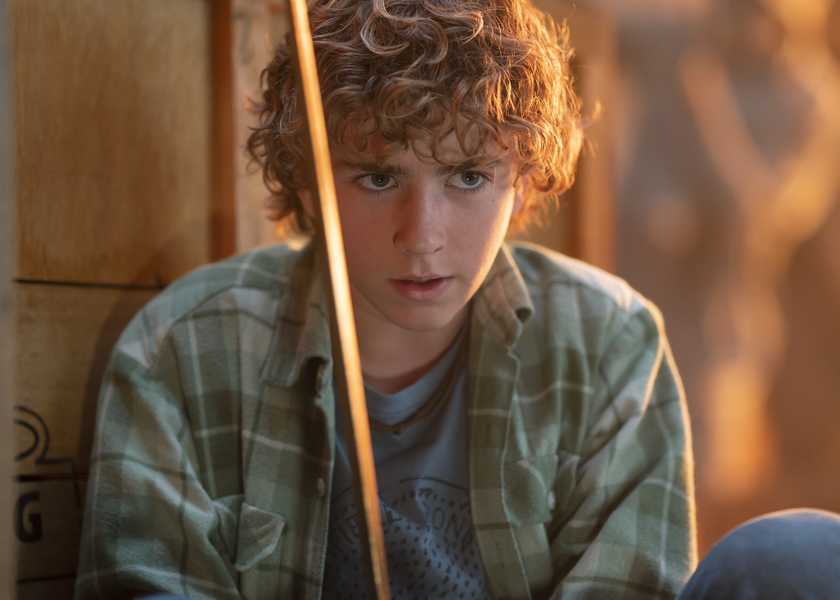 Percy holds his sword in Percy and Olympians