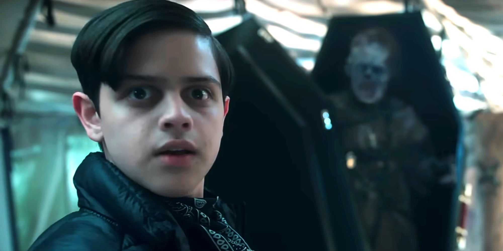 Pugsley Addams looking surprised with Slurp in the background in Wednesday season 2