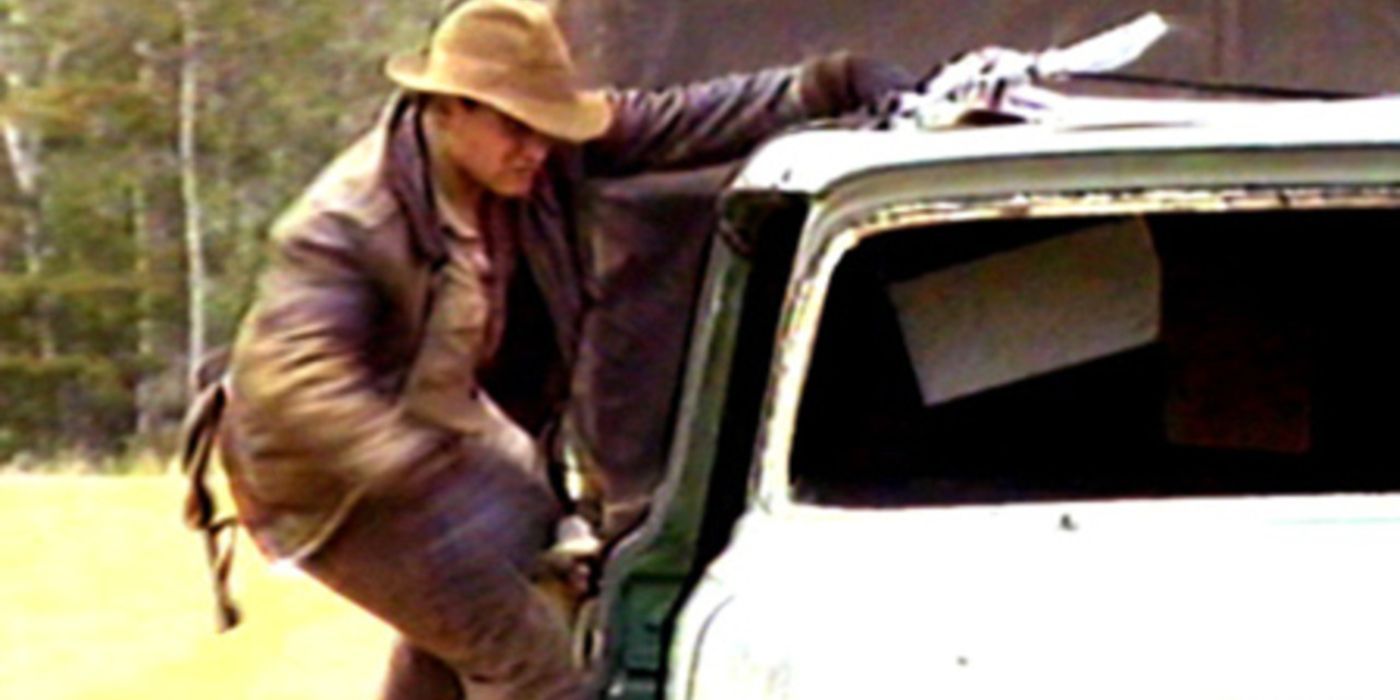 Indiana Jones hangs from the side of a moving truck in Raiders of the Lost Ark the Adaptation