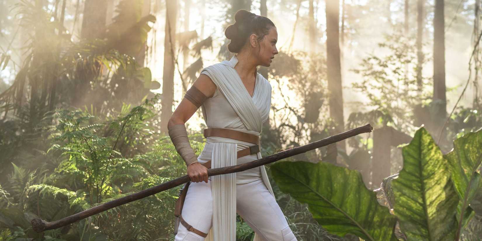Rey in The Rise of Skywalker holding a staff