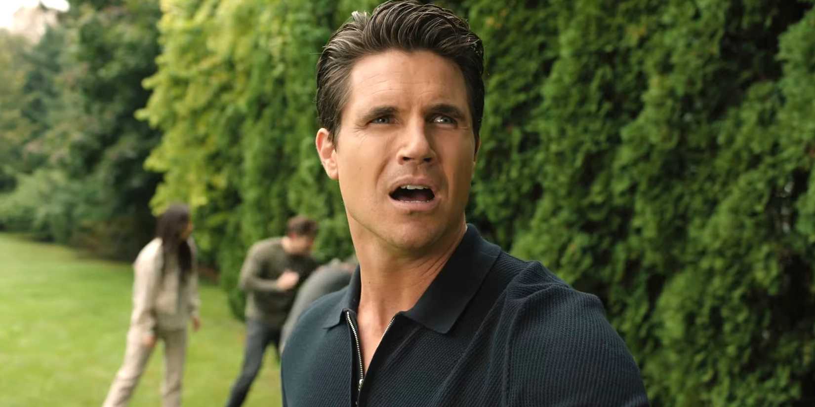 Robbie Amell as Nathan looking confused in a Lakeview area in Upload season 4