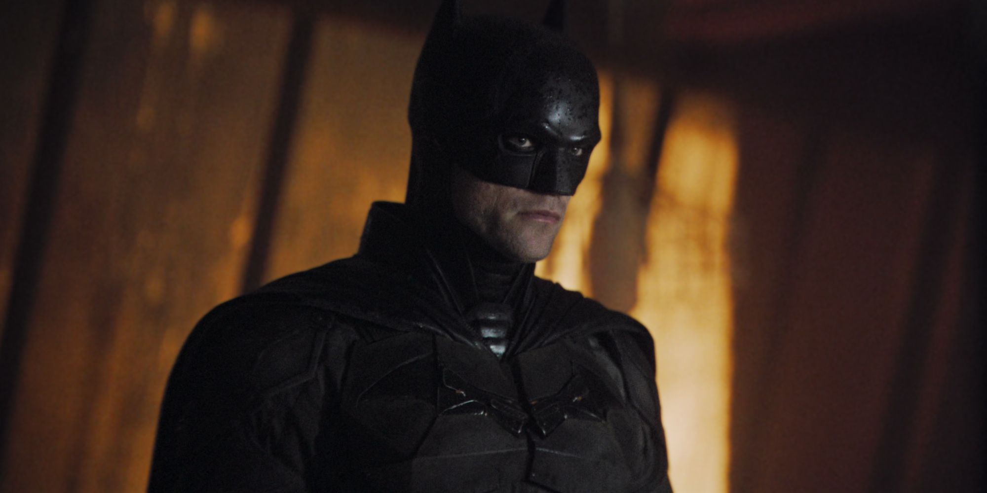 Robert Pattinson's Batman looking curious in The Batman