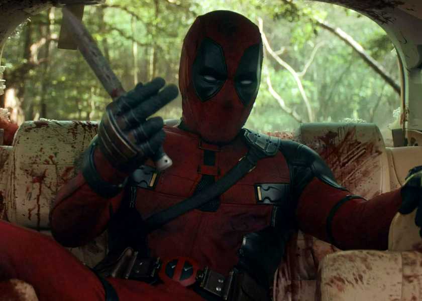 Ryan Reynolds' Deadpool motioning Hugh Jackman's Wolverine to fight in a car full of blood