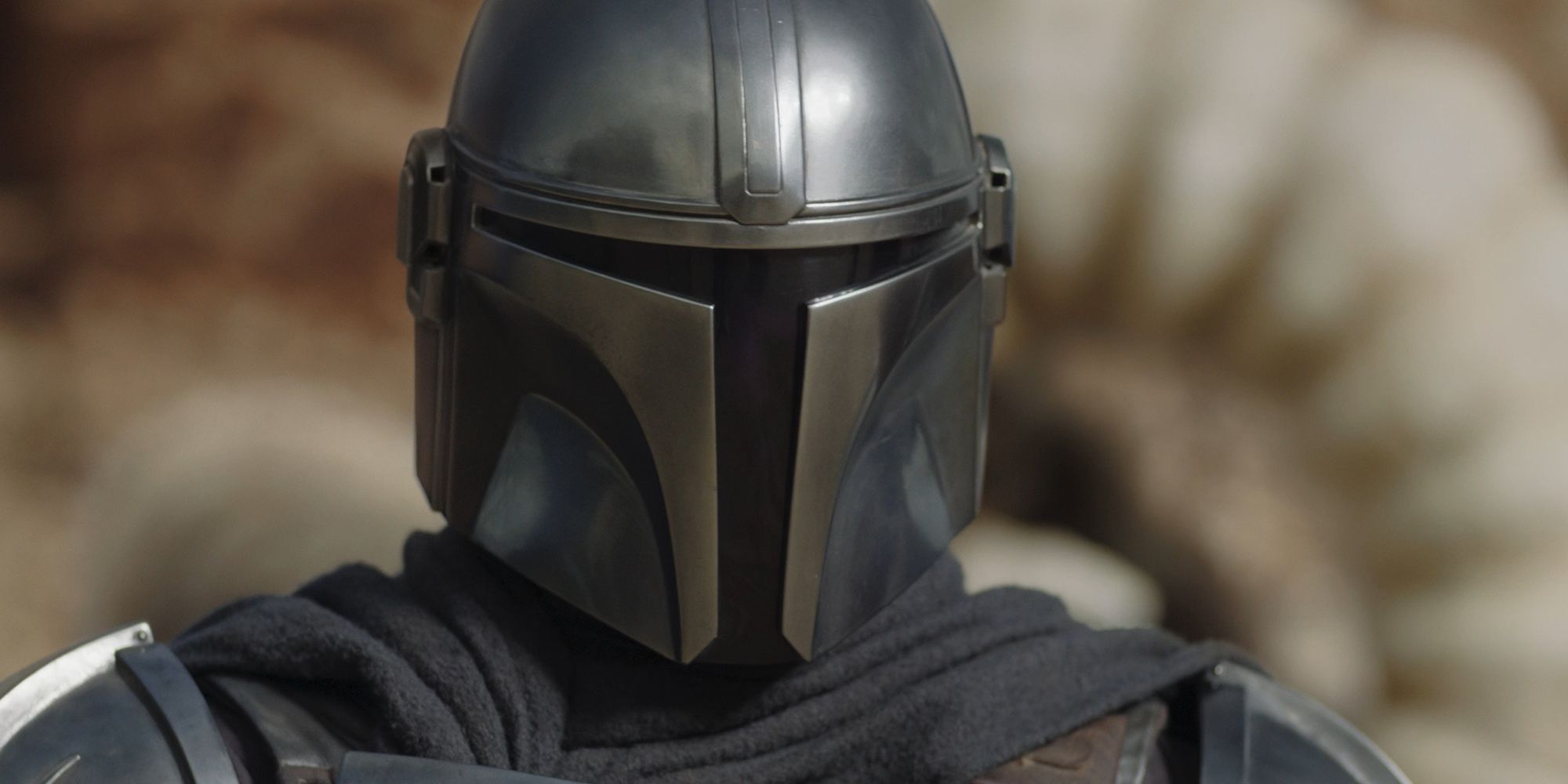 Din Djarin (Pedro Pascal) keeps his helmet focused on the krayt dragon fight on Tatooine in a super close-up.