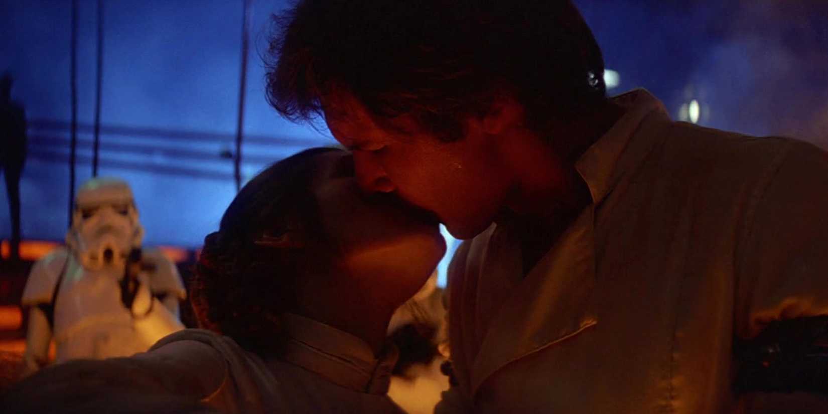 Han Solo (Harrison Ford) and Leia Organa (Carrie Fisher) kiss on Cloud City before Han's frozen in carbonite.