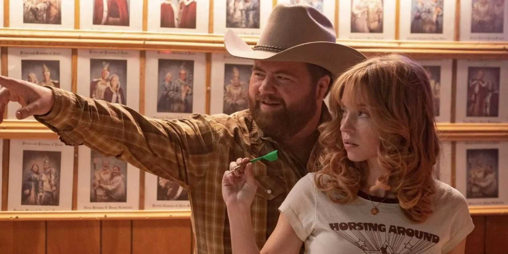 Paul Walter Hauser as Lefty Ledbetter and Sydney Sweeney as Penny Jo Poplin in Americana