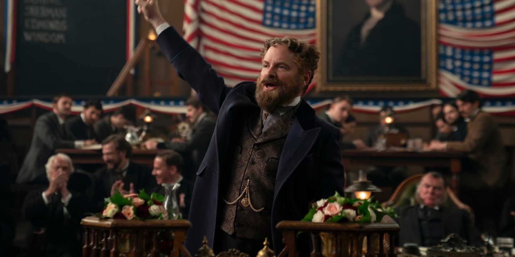 Shea Whigham as Roscoe Conkling raising his hand in a crowded room in Death by Lightning