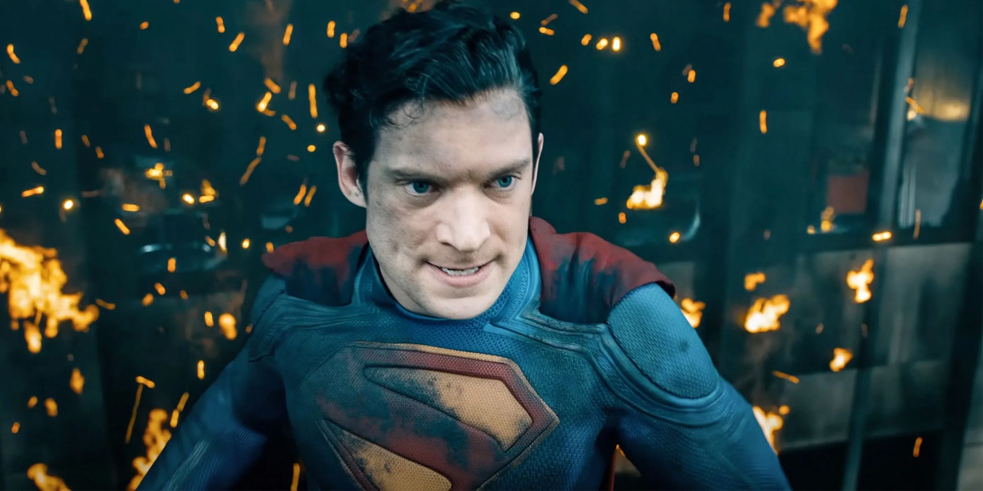 Superman flying in front of a burning building