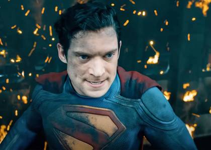 David Corenswet as Superman flying in front of a burning building