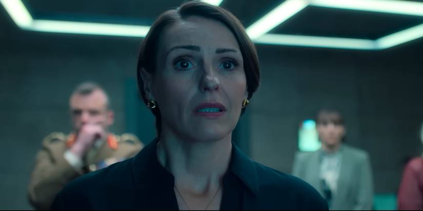 Suranne Jones as Abigail Dalton looking concerned with important figures behind her in Hostage (2025)