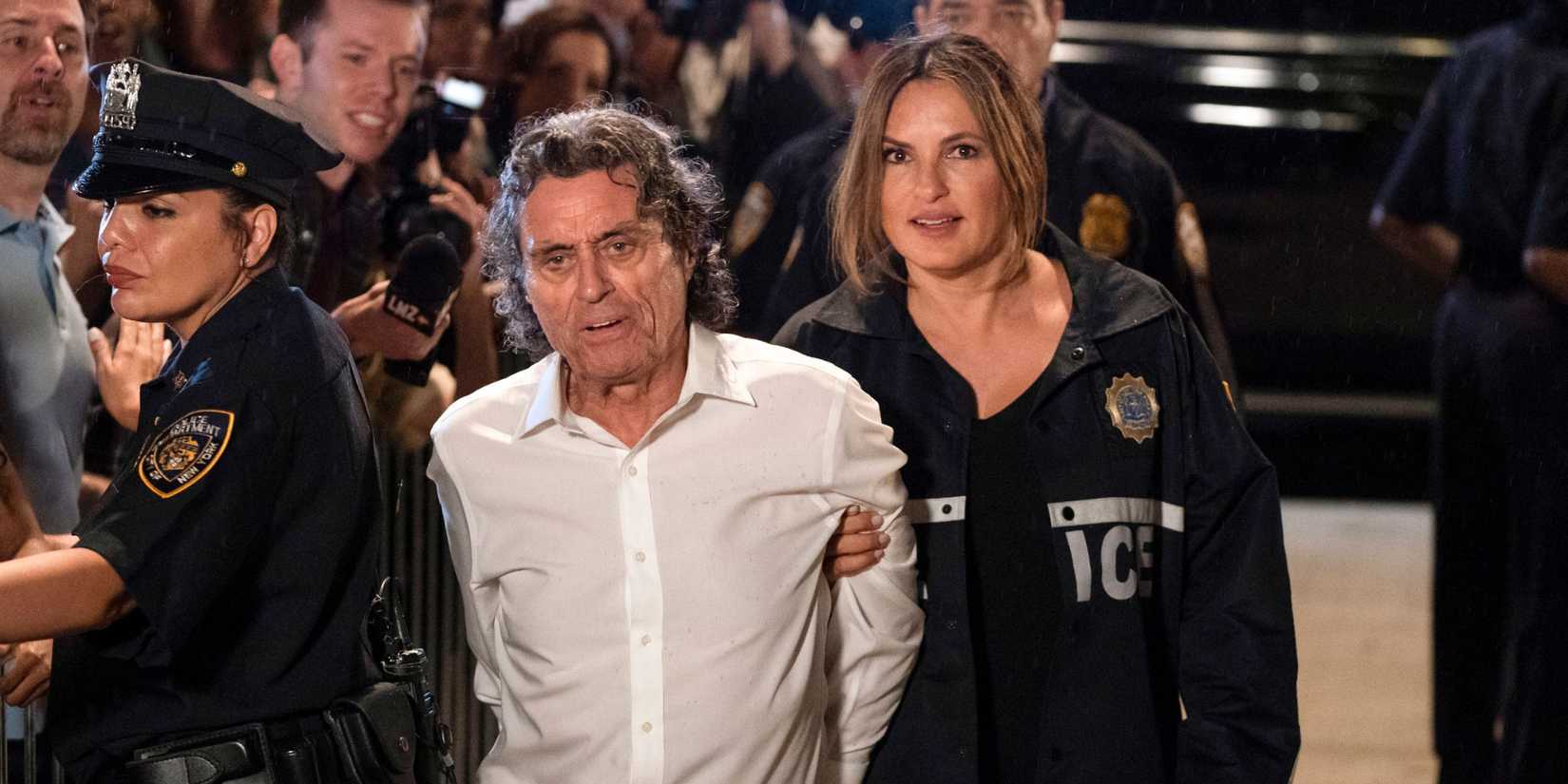 Benson (Mariska Harigtay) leading a handcuffed suspect (Ian McShane) through a crowd in the Law & Order: SVU episode "I'm Going To Make You A Star"