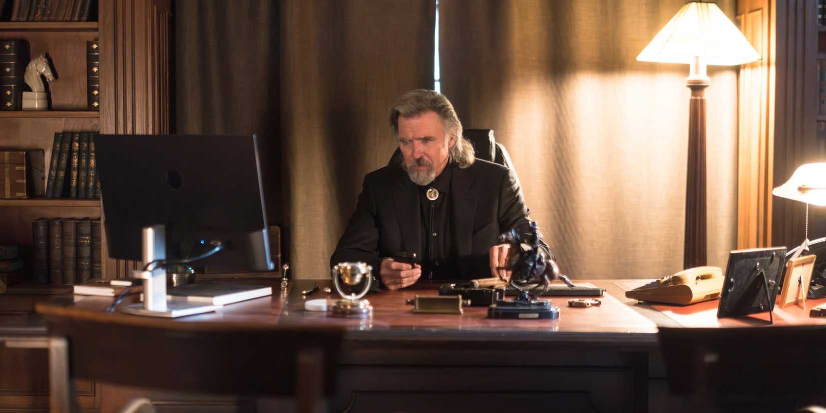 Man on the Phone (Jeff Fahey) at his desk in The Institute