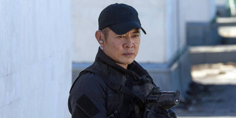 Yin looks on while holding a gun in The Expendables