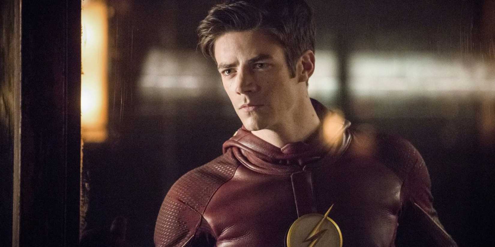 Grant Gustin suited up as The Flash while looking serious and concerned in season 2