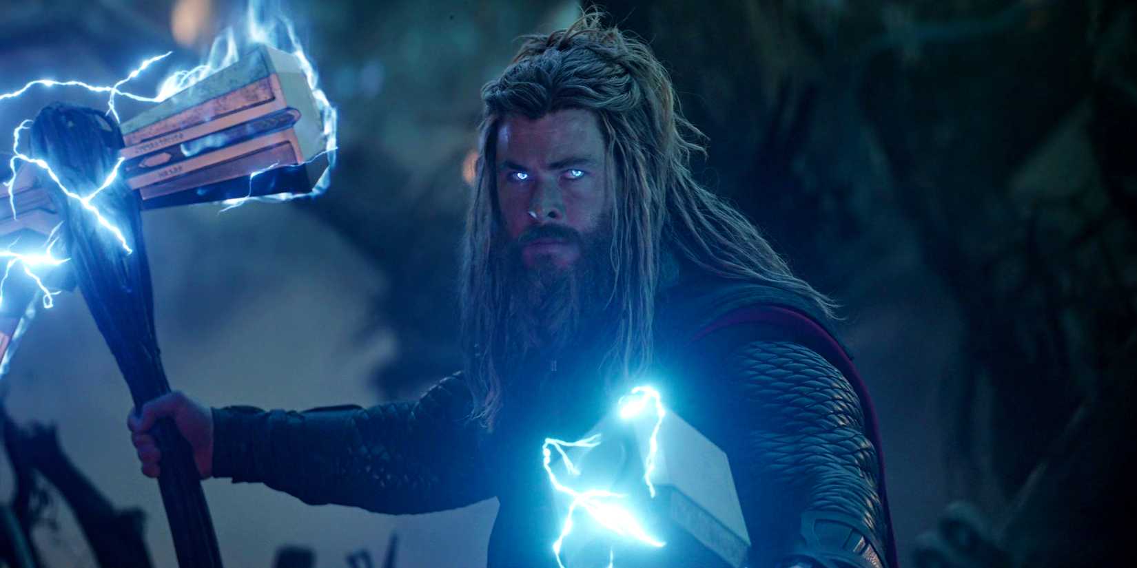 Thor wreathed in lightning with eyes glowing blue carrying Stormbreaker and Mjolnir in Avengers Endgame