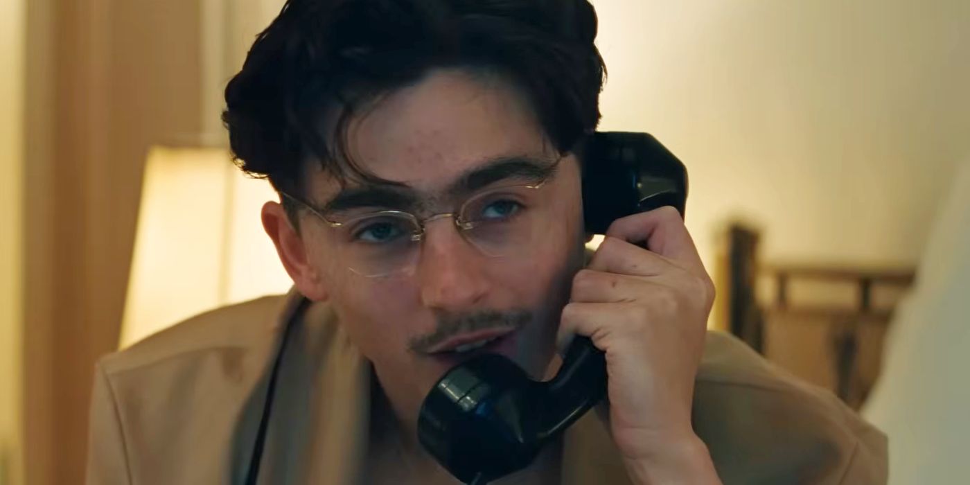 Timothee Chalamet on the phone in a hotel room in Marty Supreme