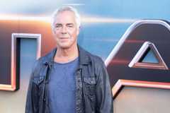 Titus Welliver smirks while standing on the red carpet for Atlas