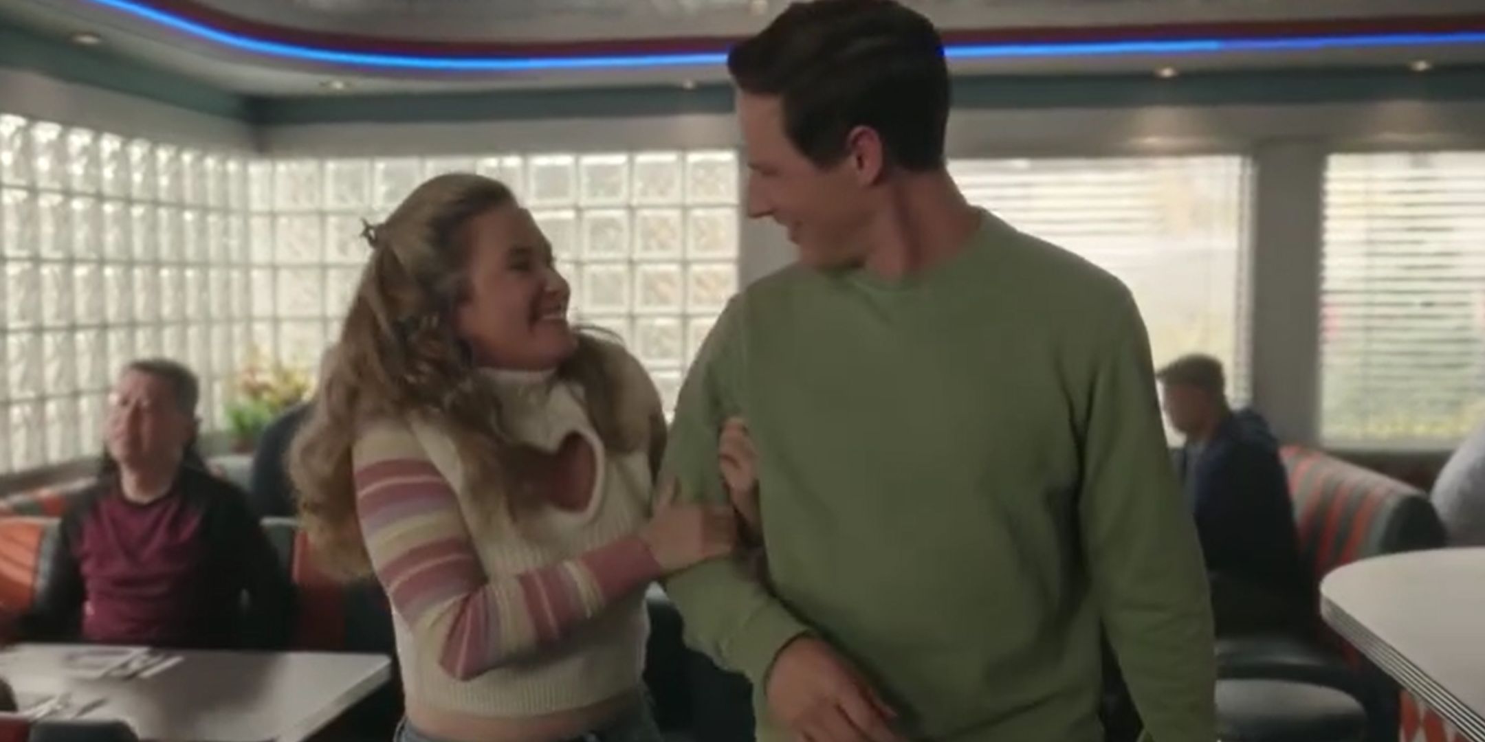 Judy holding Ethan's arm in Resident Alien