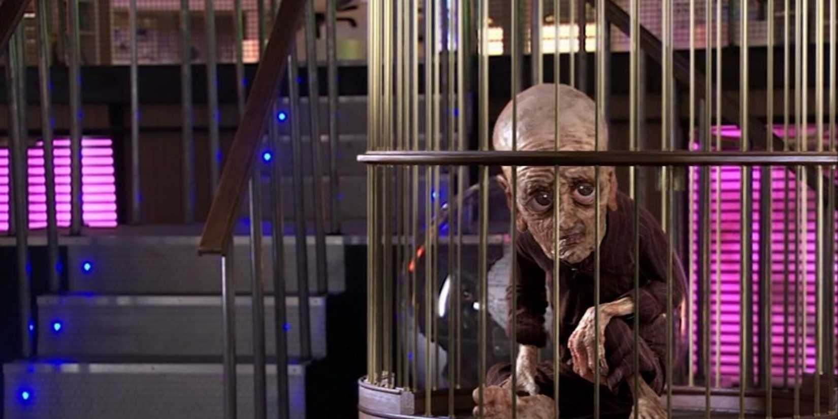 The Tenth Doctor, aged thousands of years and shrivelled, sitting in a cage on the Valiant in the Doctor Who episode "Last Of The Timelords."