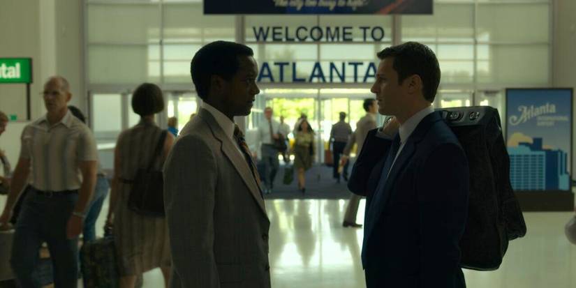 Two investigators silhouetted against the background of Atlanta airport in Mindhunter