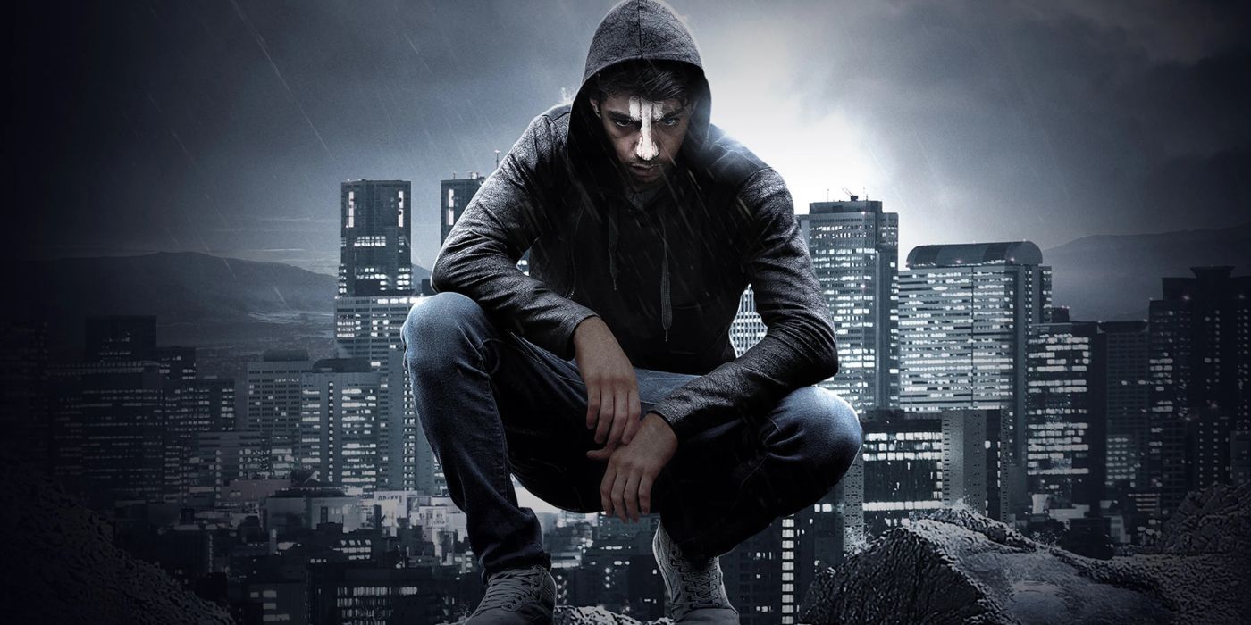 A squatting character on a roof with a hooded sweatshirt and a white face on a city background of the Australian television show Cleverman.