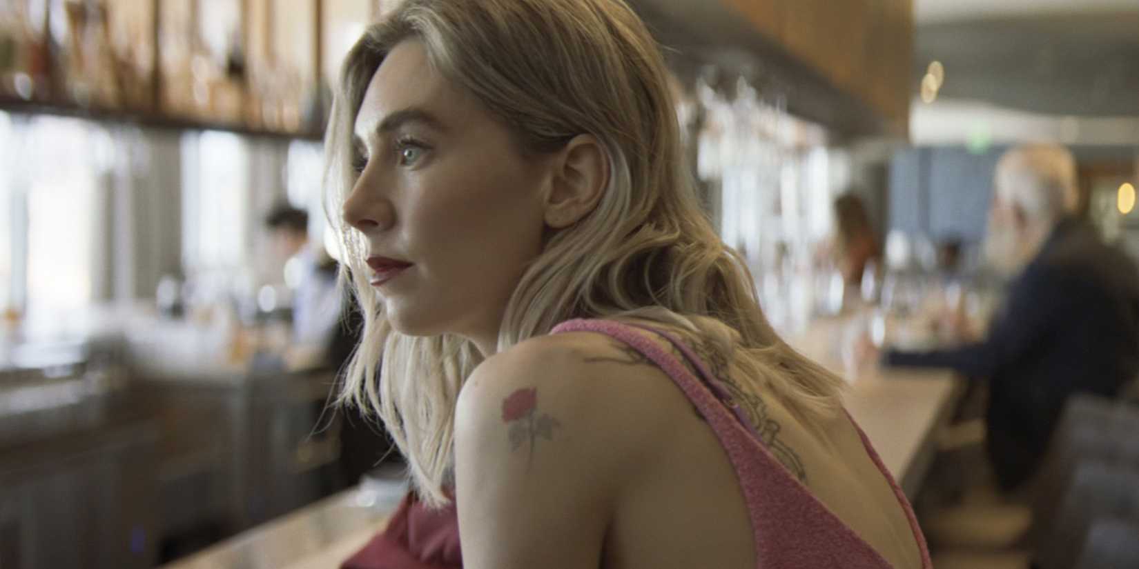 Vanessa Kirby leans across the bar in Night Always Comes
