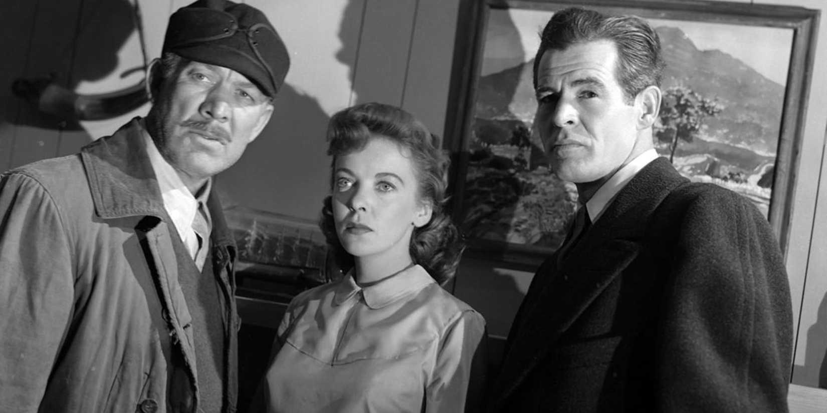 Ward Bond as Walter standing with Robert Ryan as Jim and Ida Lupino as Mary in On ᴅᴇᴀᴅly Ground
