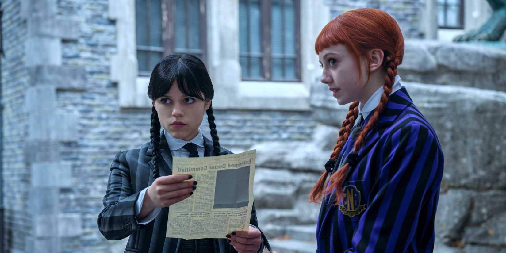 Wednesday Addams and Agnes looking at an article in Wednesday season 2