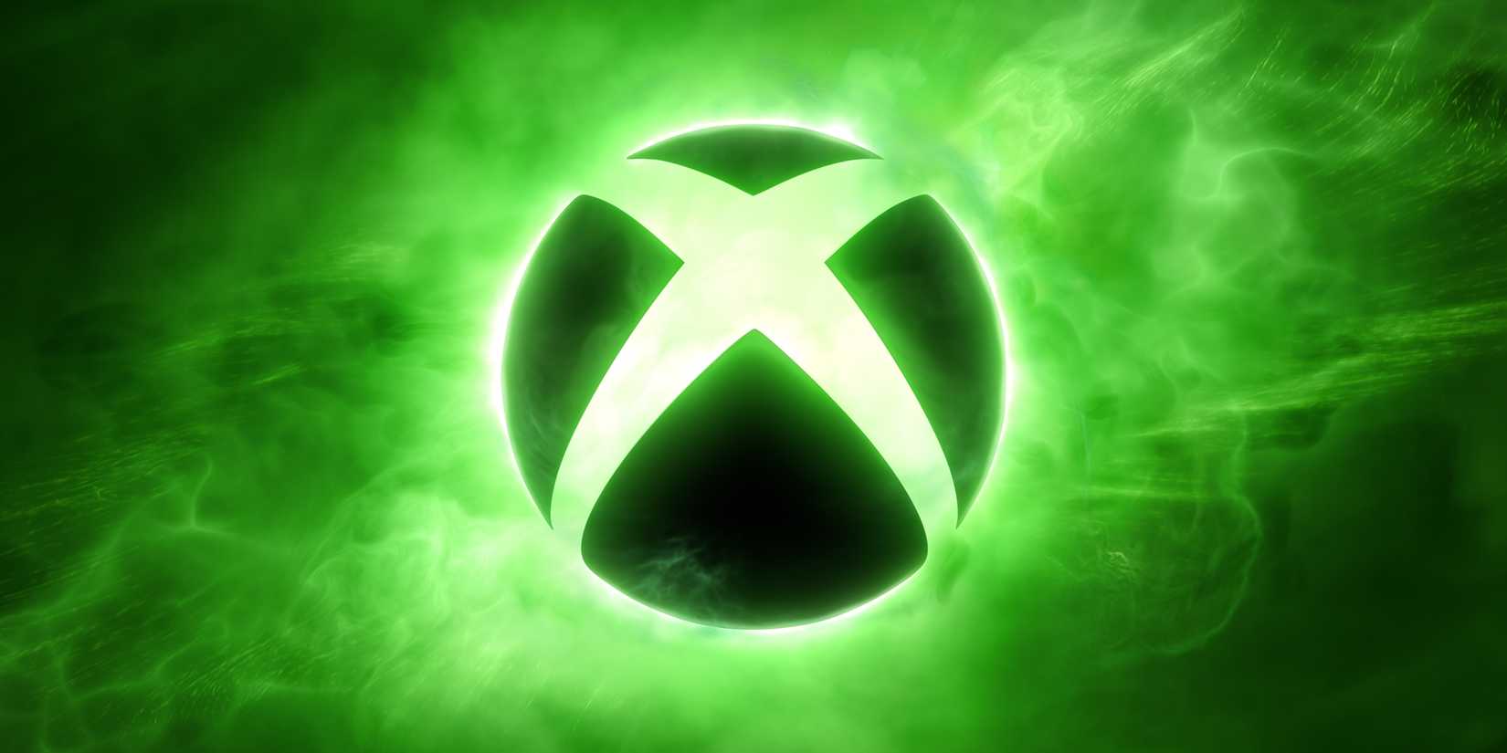 The black Xbox logo is highlighted by green lights and smoke in the background.