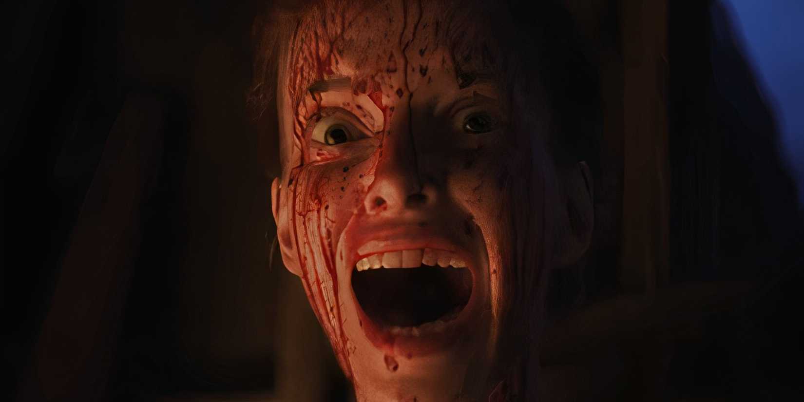 A woman with a bloodied face screaming in the horror film Keeper