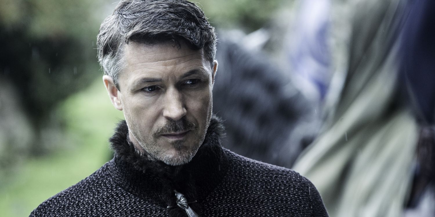 Littlefinger looking down with a serious expression in Game of Thrones.