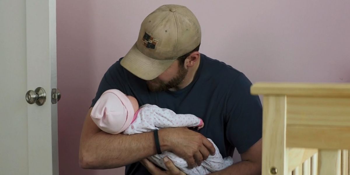 Bradley Cooper holding a fake baby in American Sniper