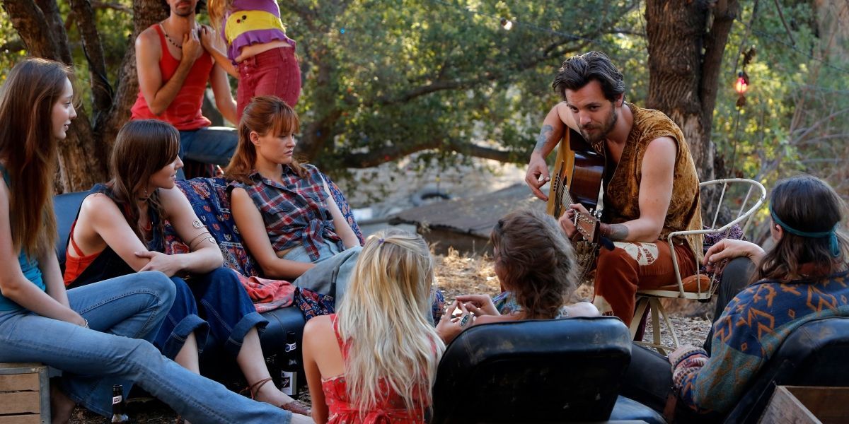 The Manson Family gathers around a campfire in Aquarius