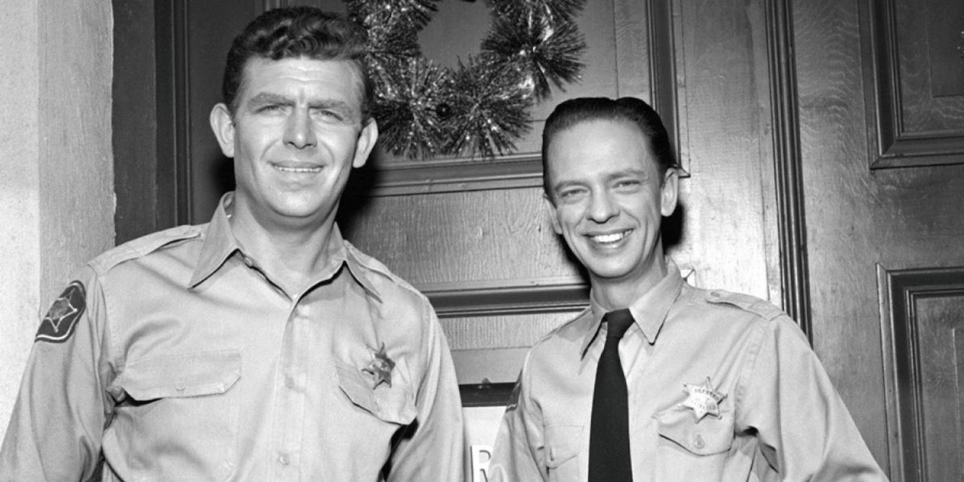 Andy Griffith standing beside Don Knotts in front of a door for The Andy Griffith Show