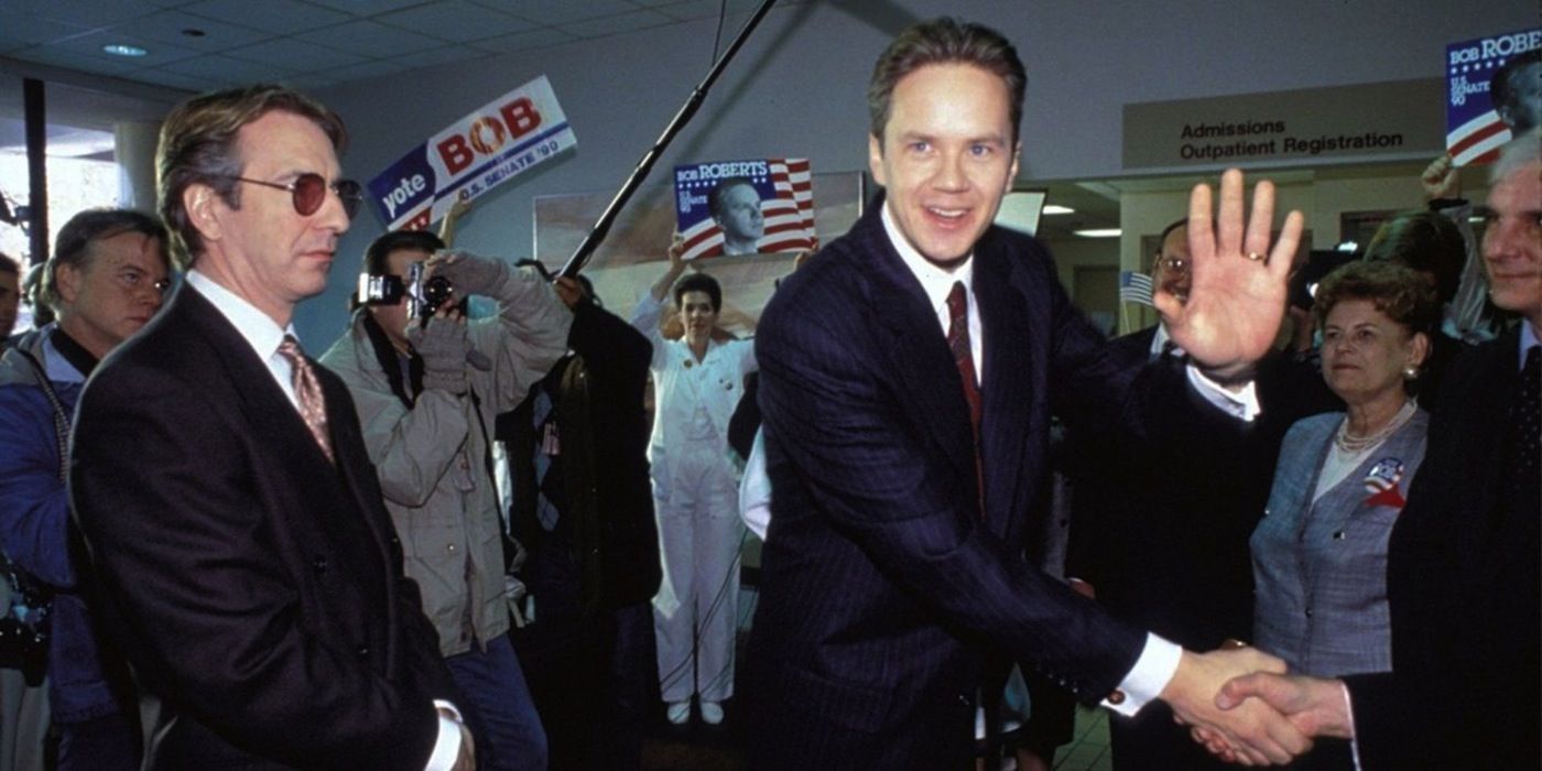 Tim Robbins from the movie Bob Roberts, shaking hands with people during a political event.