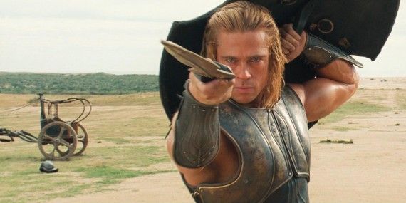 Brad Pitt raising a shield and pointing a sword in Troy